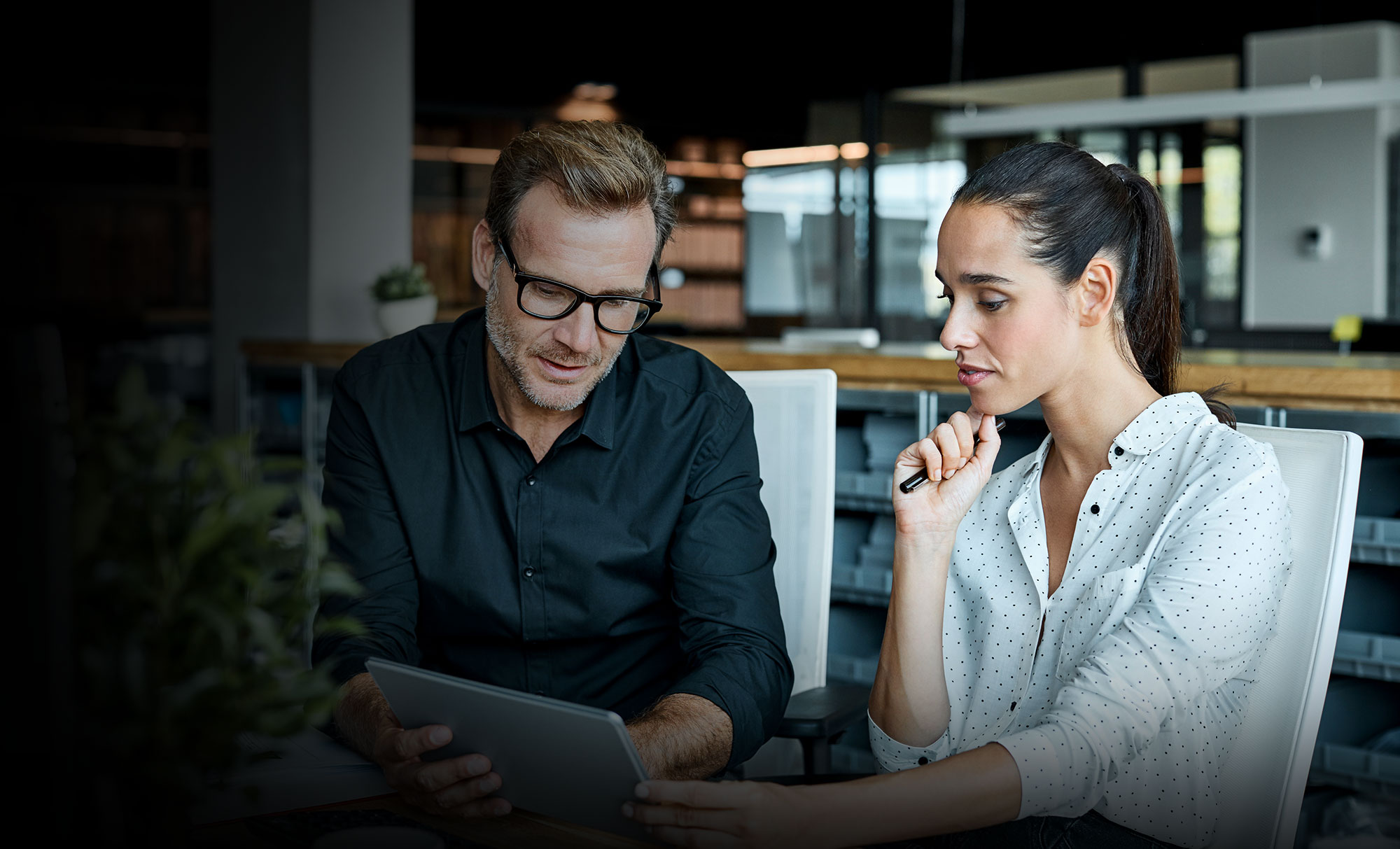 Man and woman looking at ipad