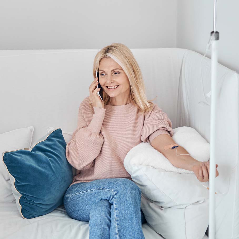 Happy woman receiving IV therapy at Serotonin Centers.