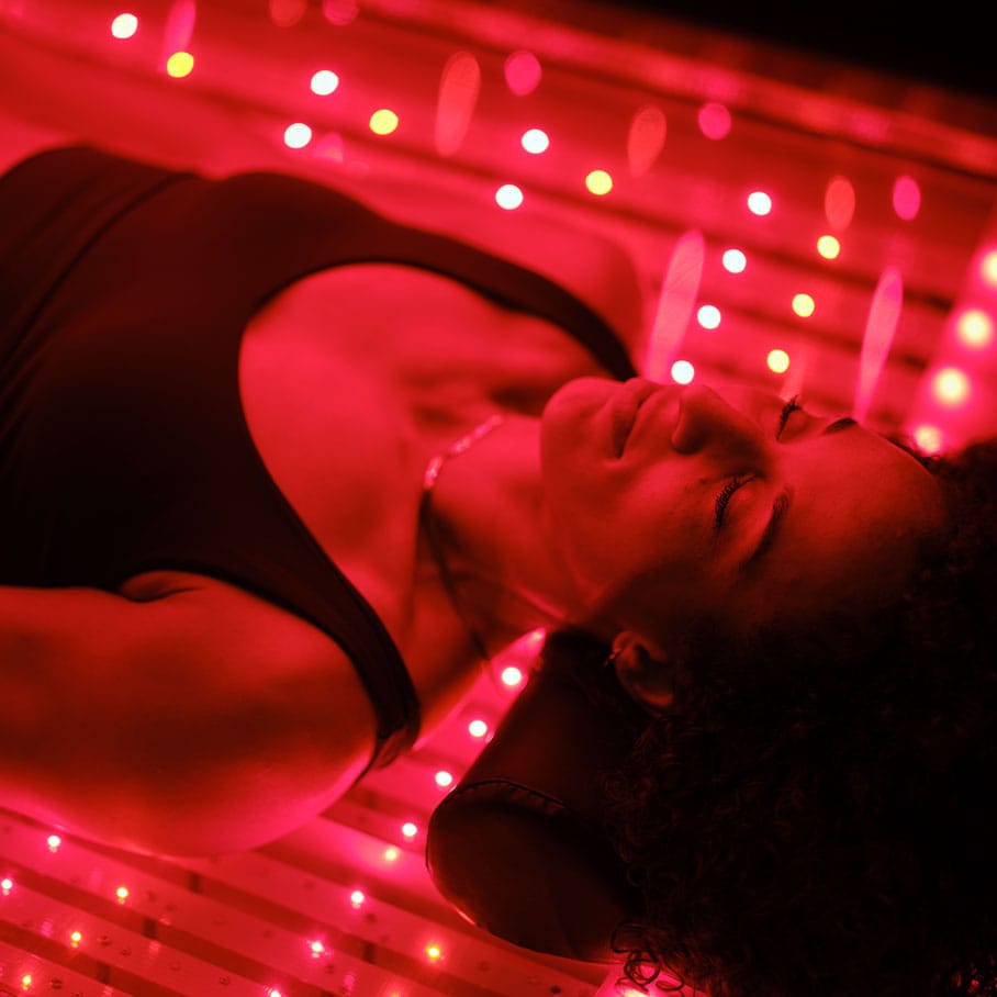 woman receiving red light therapy in a bed in Lake Nona, FL