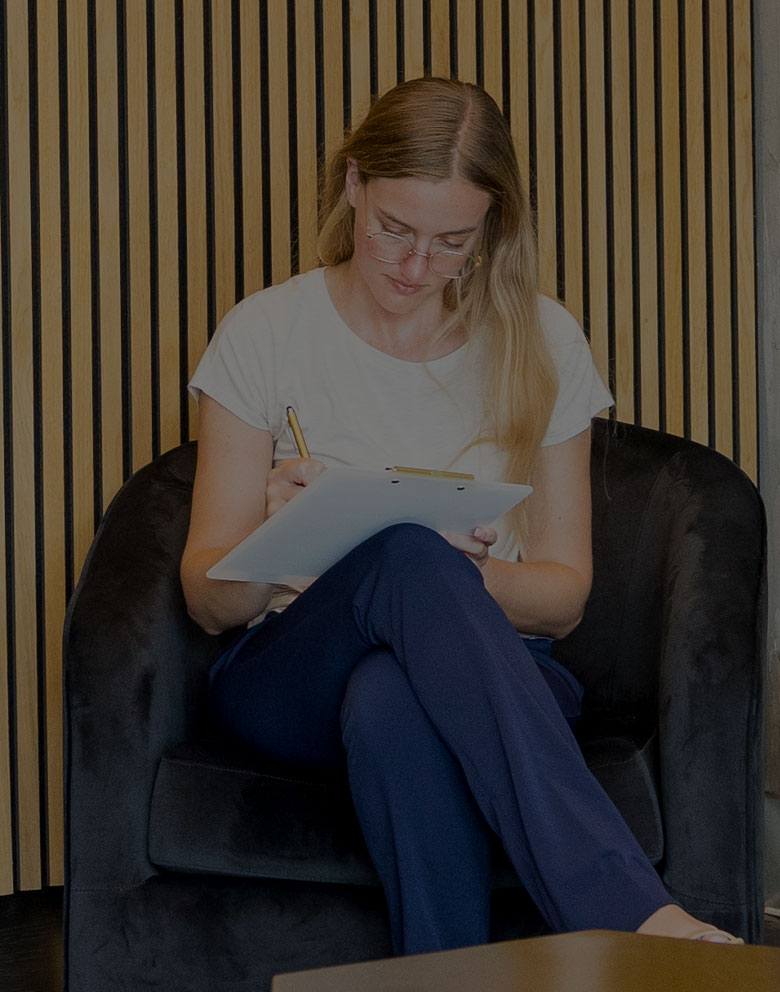 woman filling out paperwork in Serotonin Centers lobby in Del Mar, CA