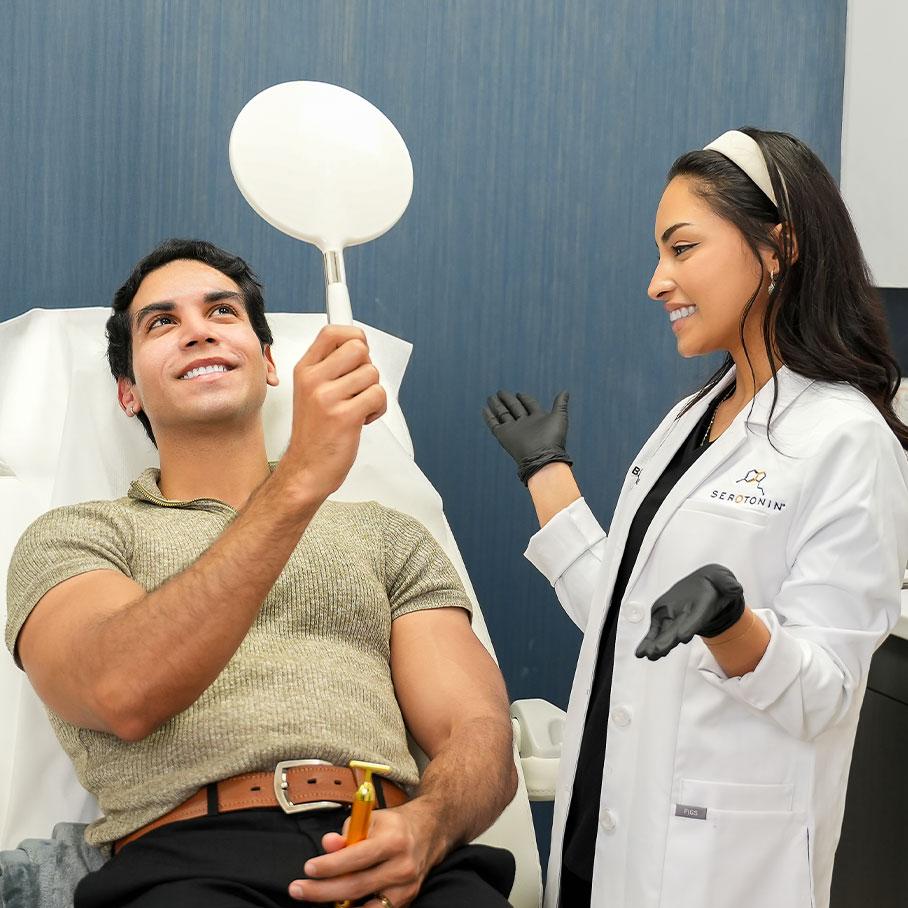 man looks at results in the mirror after Sculptra treatment in Fort Worth, TX