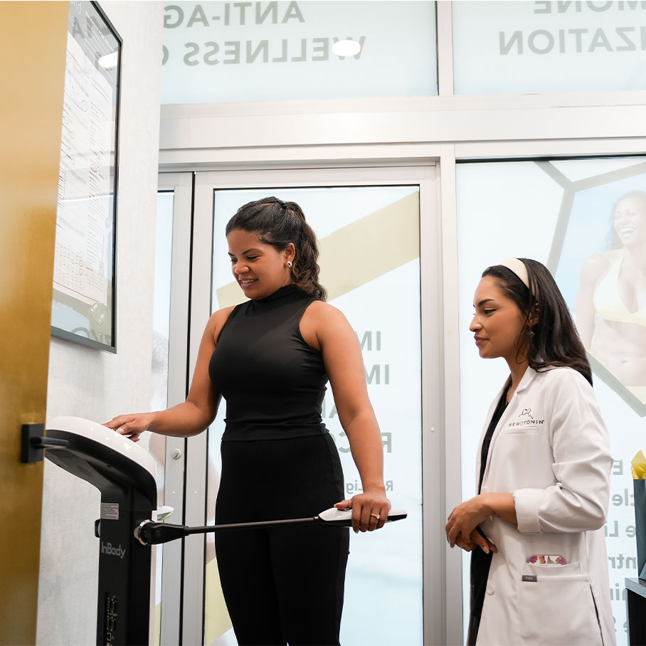 woman weighting herself on scale with weight loss coach in Naperville