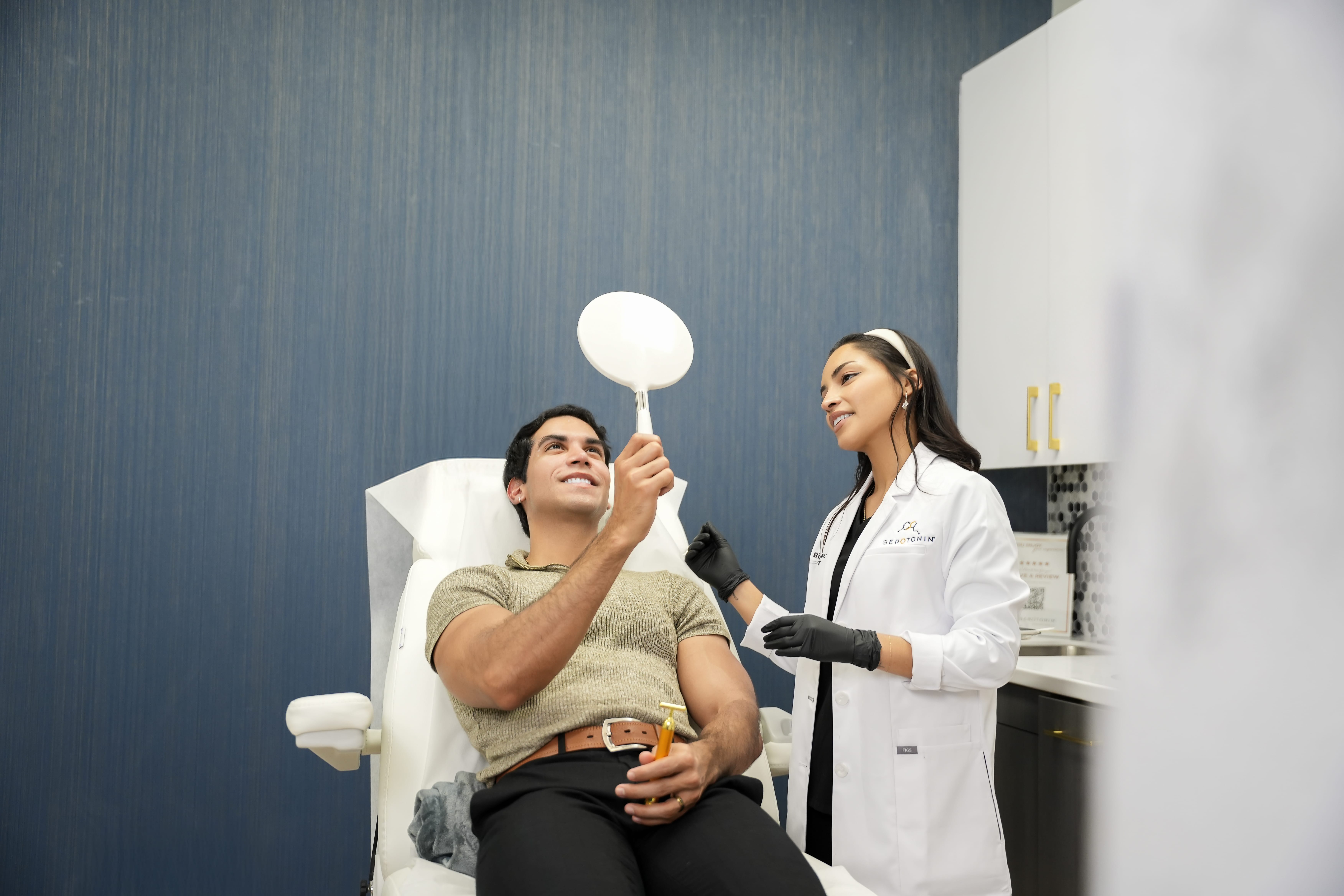 patient looking in mirror after Dysport treatment in Fort Worth