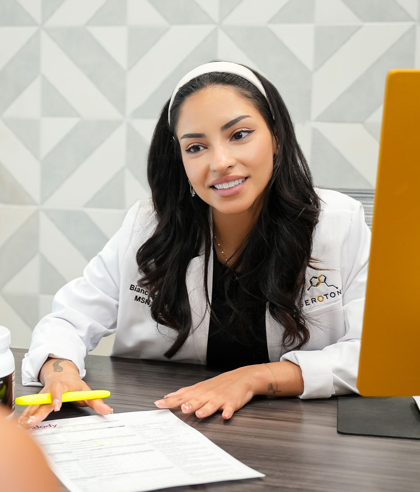 Serotonin med spa team member presenting documents in Fort Worth, TX